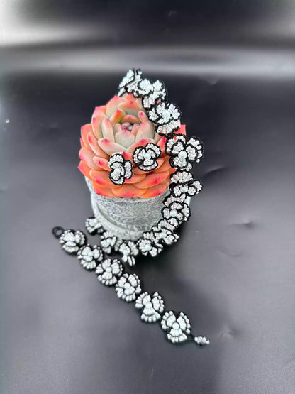 Handcrafted Classic White Camellia beaded stud earrings with white glass beads and black woven edges.A pair in the picture.