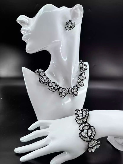 Handcrafted Classic White Camellia beaded stud earrings with white glass beads and black woven edges. A single in the picture.