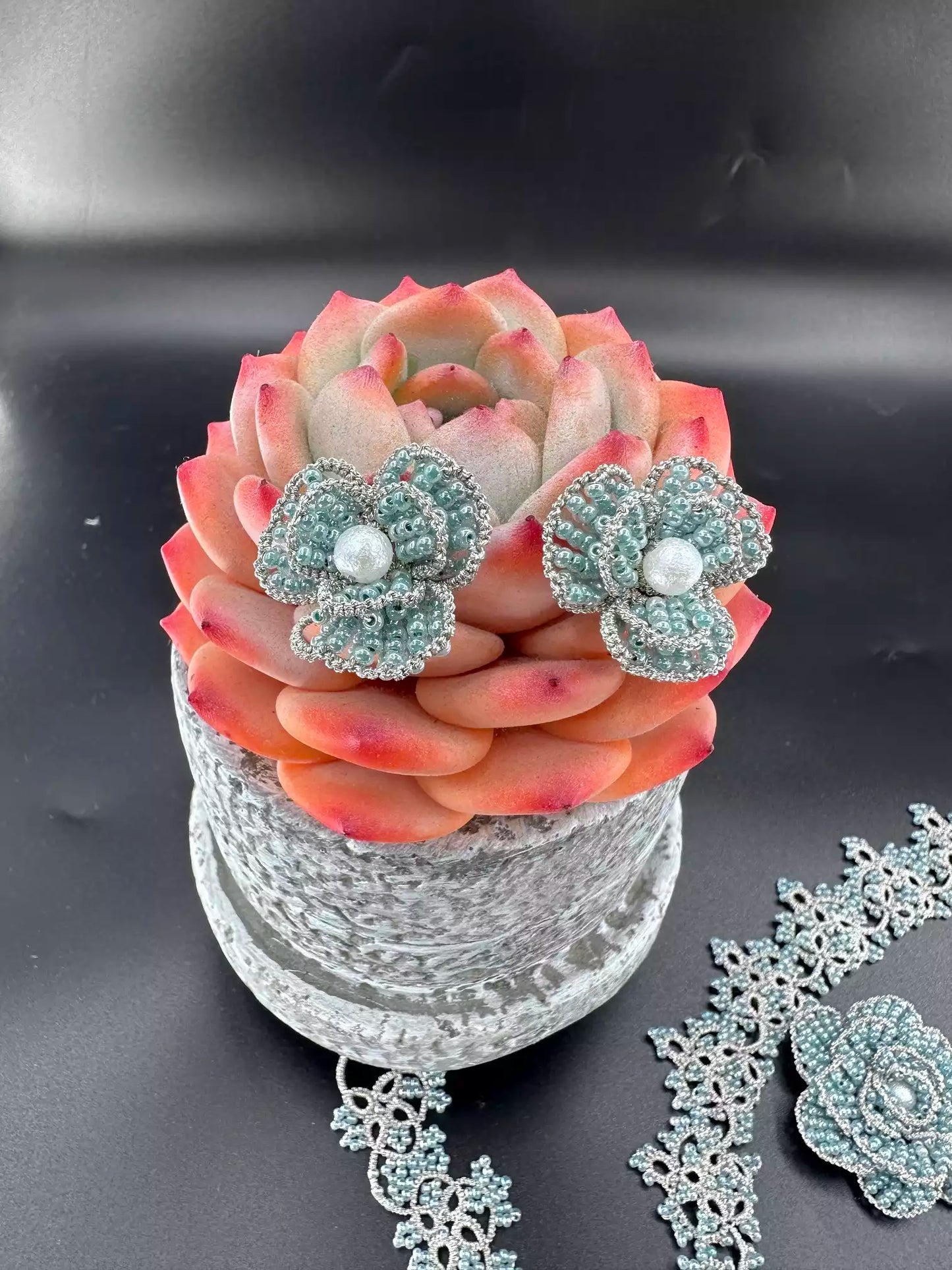 Handcrafted Emerald & Gold Camellia beaded stud earrings with green glass beads and golden woven edges, a pair in the picture.