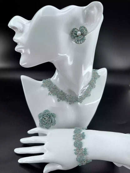 Handcrafted Emerald & Gold Camellia beaded stud earrings with green glass beads and golden woven edges. A single in the picture.