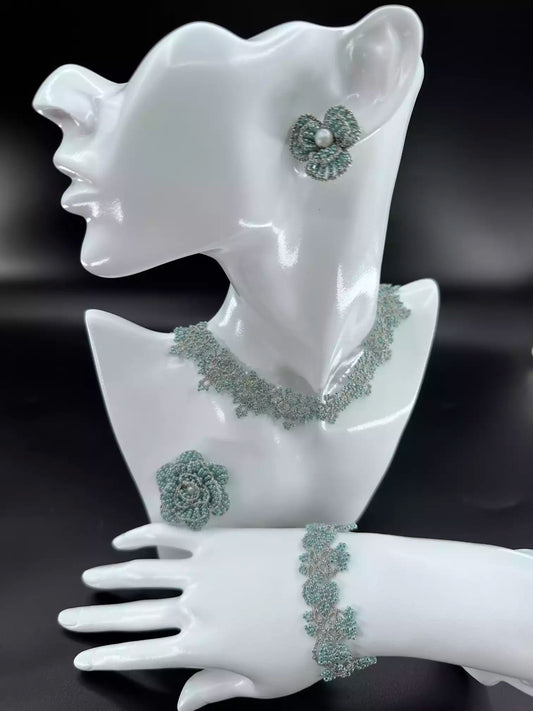 Handcrafted Emerald & Gold Camellia beaded stud earrings with green glass beads and golden woven edges. A single in the picture.