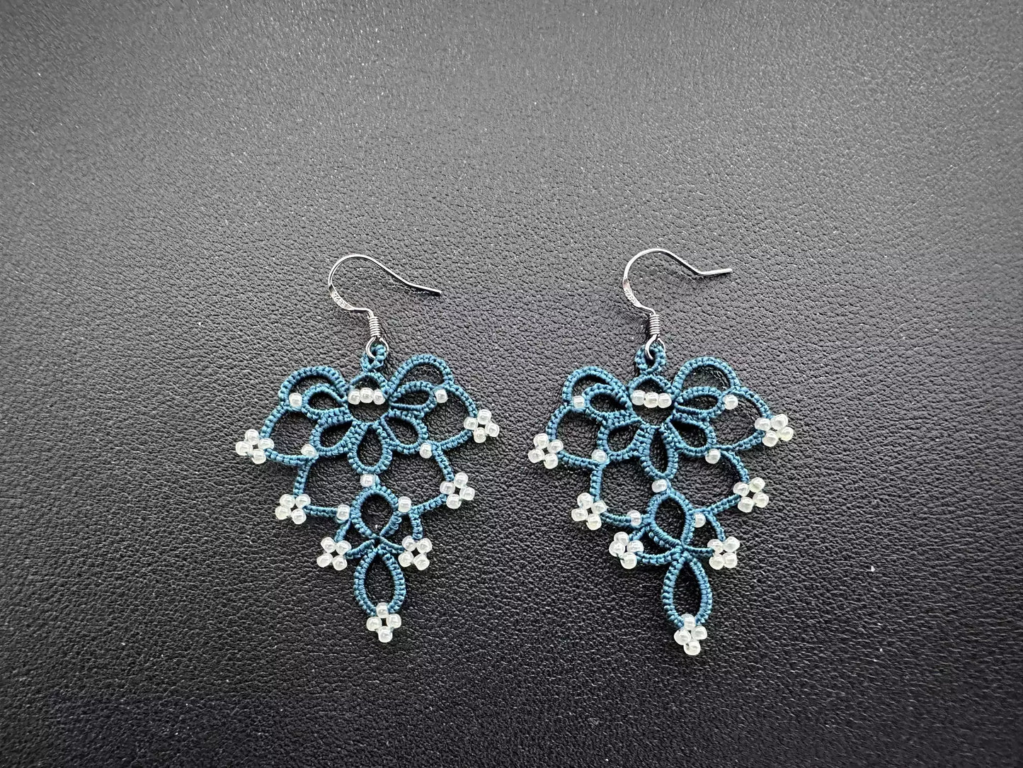Elegant Floral Bell Earrings hand-knitted with serene indigo thread and pristine white glass beads, showcasing a fresh and refined flower-like design