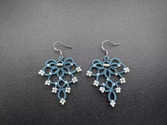 Elegant Floral Bell Earrings hand-knitted with serene indigo thread and pristine white glass beads, showcasing a fresh and refined flower-like design