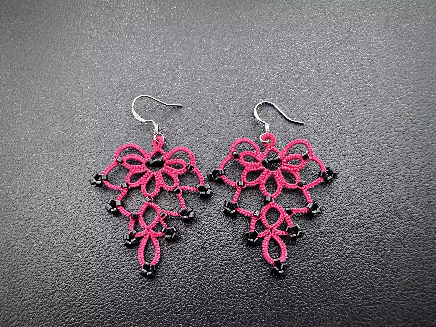 Handcrafted Floral Bell Earrings featuring intricate shuttle-knitted red thread and dangling black glass beads, designed in a delicate flower-like shape