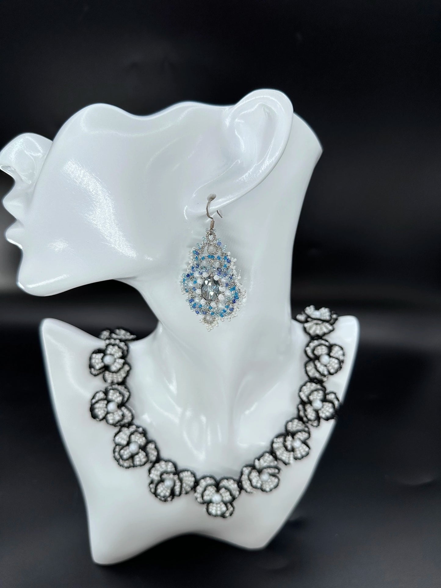 Elegant Corelight drop earring in captivating blue-white hues, featuring delicate silver **tatted lace** weaving and luminous glass bead clusters for a refined artisan look