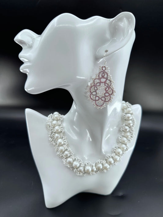 Close-up of a handcrafted Gourdlet dangle earring featuring delicate purple threadwork and clustered white glass beads, perfect for elegant styles