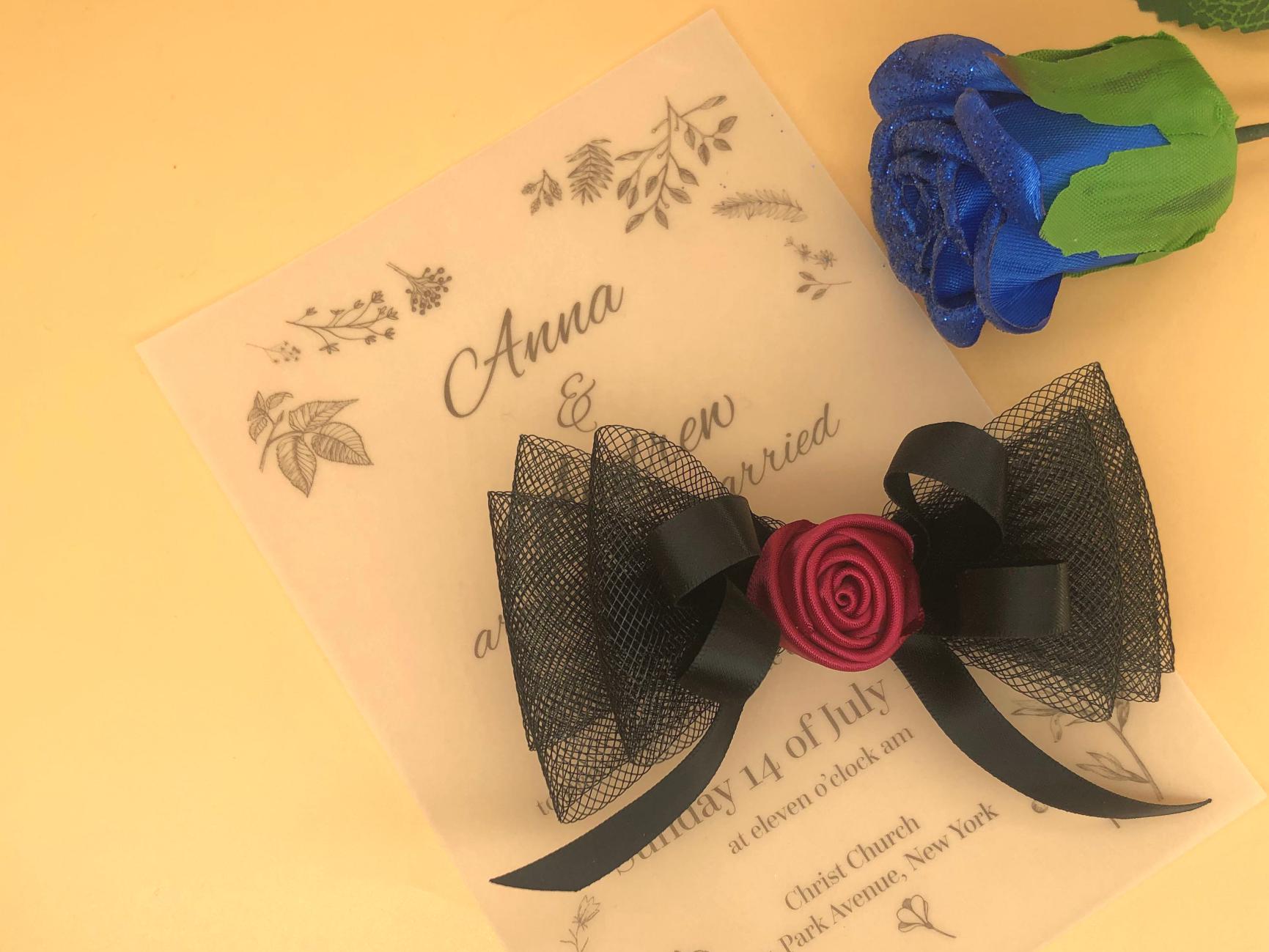 Handmade black layered tulle mesh hair clip with a central red ribbon rose and a delicate black ribbon tie.